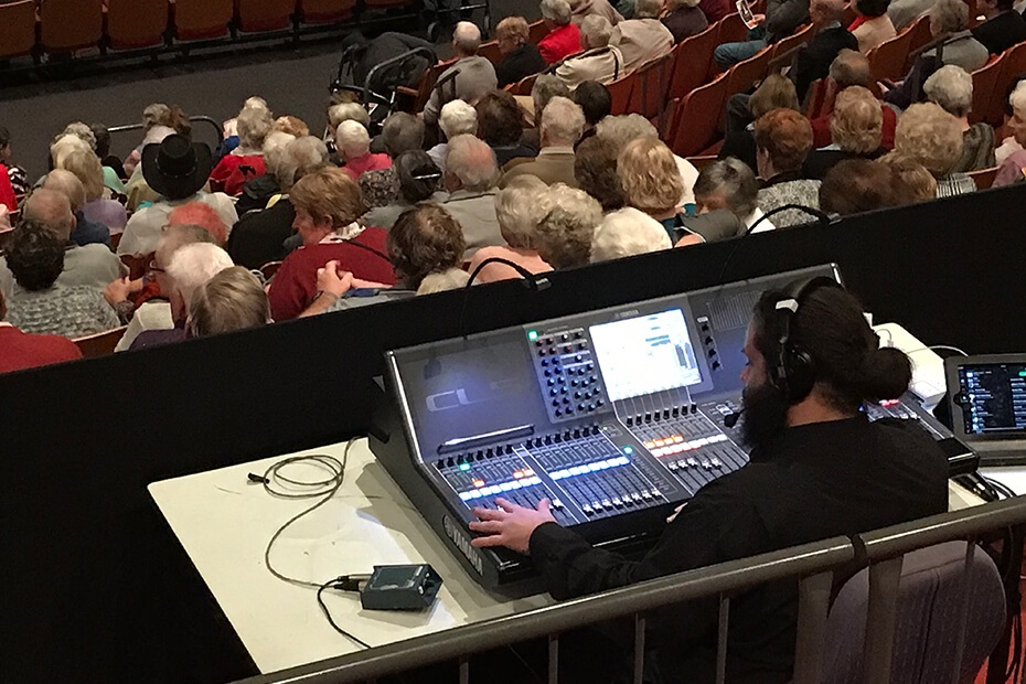 A sound technician working behind the sound desk at the Shoalhaven Entertainment Centre
